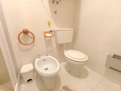 a white bathroom with a toilet and a bidet at Apartment Appartamento Matilde by Interhome in Penia
