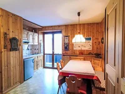 a kitchen with a table in the middle of it at Apartment Nuccia Navalge by Interhome in Moena