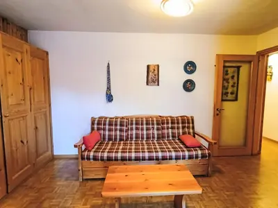 a living room with a couch and a table at Apartment Nuccia Navalge by Interhome in Moena