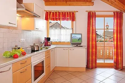 a kitchen with a counter and a television in it at Apartment Walder in Fiumes