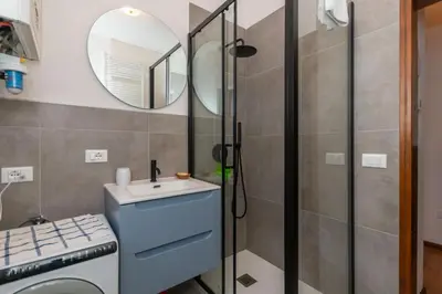 a bathroom with a sink and a mirror at El Barance-Boscoverde 2 in Sottoguda
