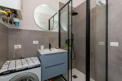 a bathroom with a sink and a mirror at El Barance-Boscoverde 2 in Sottoguda