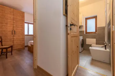 a bathroom with a toilet and a sink and a tub at El Mugo-Boscoverde 1 in Sottoguda