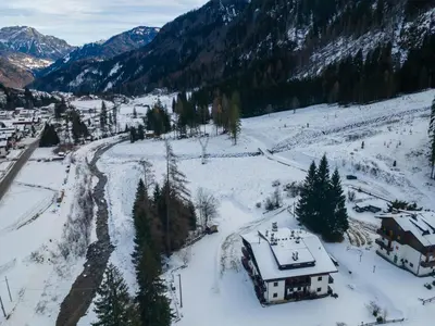 an aerial view of a snow covered mountain at El Mugo-Boscoverde 1 in Sottoguda