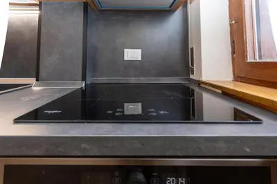 a kitchen with a black stove top oven at El Mugo-Boscoverde 1 in Sottoguda