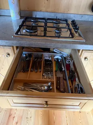 a drawer in a kitchen with a stove and utensils at Precumon 8'1 in Arabba