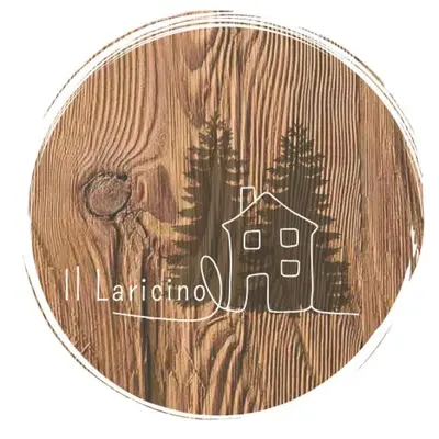 a medal with a picture of a house and trees at Il Laricino in Predazzo