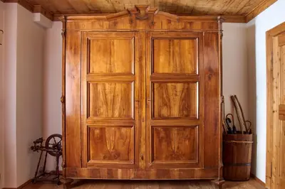 a wooden cabinet in the corner of a room at Dimora Nobile d'Ottocento - parcheggio interno in Cortina dʼAmpezzo
