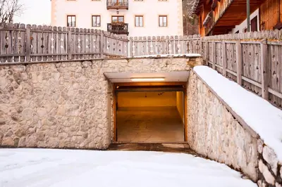 a tunnel in a wall with snow on the ground at Dimora Nobile d'Ottocento - parcheggio interno in Cortina dʼAmpezzo