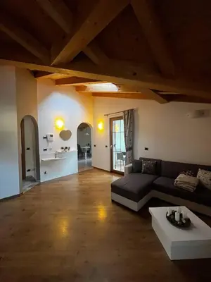 a large living room with a couch and a table at Cèsa Nicole e Patrick in Campitello di Fassa