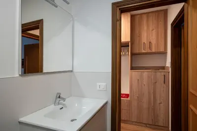a bathroom with a sink and a mirror at Happiness 14 in Castello di Fiemme