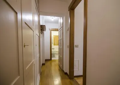 a hallway with an open door to a bathroom at Cortina da vivere il tuo rifugio a due passi da tutto in Cortina dʼAmpezzo