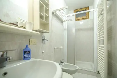 a bathroom with a sink and a toilet and a shower at Cortina da vivere il tuo rifugio a due passi da tutto in Cortina dʼAmpezzo