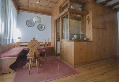 a dining room with a table and a chair at La tua coccola a Cortina in Cortina dʼAmpezzo
