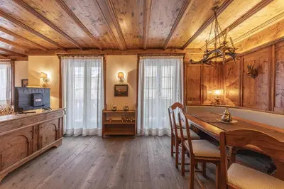 a kitchen with a wooden ceiling and a table and chairs at Casa Lana, comfort nel centro di Cortina d Ampezzo in Cortina dʼAmpezzo