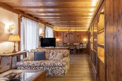 a living room with a couch and a table at Casa Lana, comfort nel centro di Cortina d Ampezzo in Cortina dʼAmpezzo