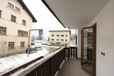a balcony with a view of a snow covered street at Casa Lana, comfort nel centro di Cortina d Ampezzo in Cortina dʼAmpezzo