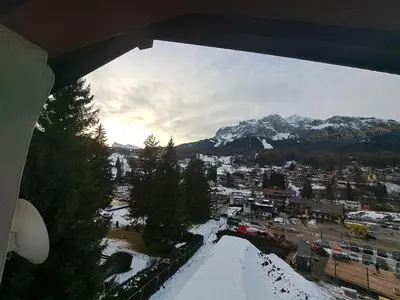 a view of a city with snow covered mountains at Luminoso e centralissimo attico, splendida vista panoramica sulle Dolomiti e sulle piste olimpiche in Cortina dʼAmpezzo