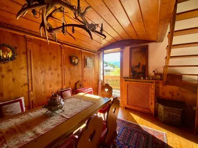 a dining room with a table and chairs in a cabin at Classy typical apartment in Alvera' in Cortina dʼAmpezzo