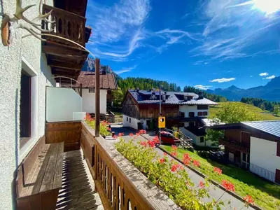 a balcony of a building with a view of a town at Classy typical apartment in Alvera' in Cortina dʼAmpezzo