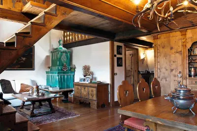 a living room with a table and a green pot at Classy typical apartment in Alvera' in Cortina dʼAmpezzo