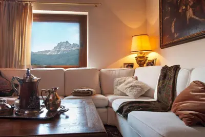 a living room with a couch and a table at Classy typical apartment in Alvera' in Cortina dʼAmpezzo