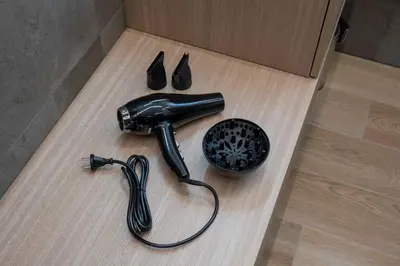 a hairdryer and a hair dryer on a wooden floor at La Corte Delle Dolomiti in Agordo