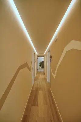an empty hallway with a row of lights on the wall at La Corte Delle Dolomiti in Agordo