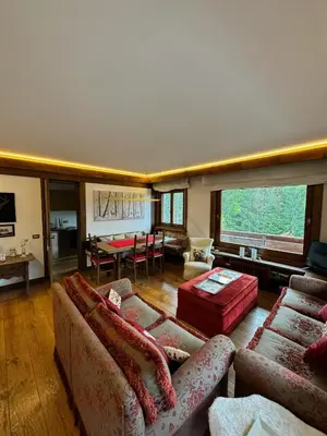 a large living room with couches and a dining room at Via Cantore Exclusive Stay in Cortina dʼAmpezzo