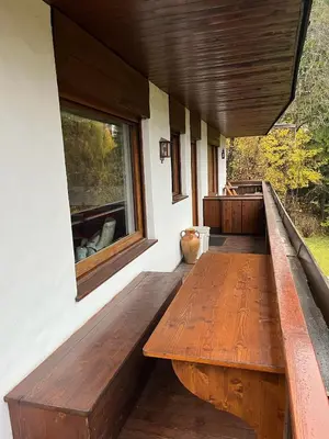 a large wooden bench on the side of a house at Via Cantore Exclusive Stay in Cortina dʼAmpezzo