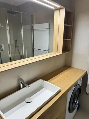 a bathroom with a sink and a washing machine at Via Cantore Exclusive Stay in Cortina dʼAmpezzo