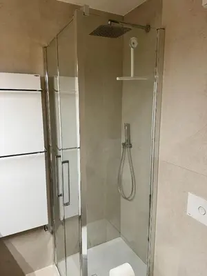 a shower with a glass door in a bathroom at Via Cantore Exclusive Stay in Cortina dʼAmpezzo