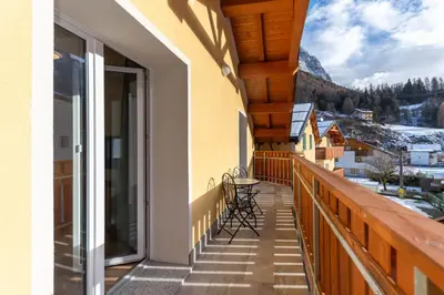 a balcony with a view of the mountains at Hapina Dolomiti with Garage in Cencenighe
