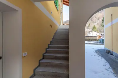 a staircase in a building with snow on the ground at Hapina Dolomiti with Garage in Cencenighe