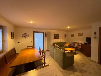 a living room with a couch and a table at Appartamento Fontane in Panchia