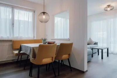 a dining room with a table and chairs at Kronsun Percha in Perca