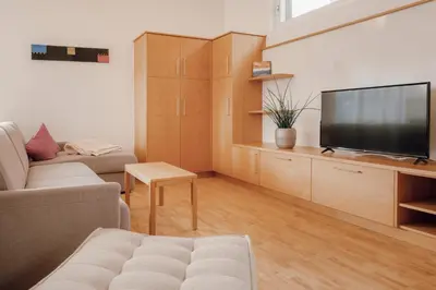 a living room with a couch and a television at Kronsun Percha in Perca