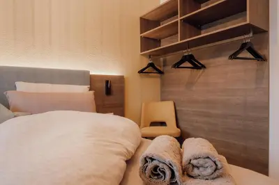 a bedroom with a bed with towels on it at Kronsun Percha in Perca