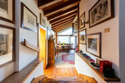 a hallway of a house with wooden floors and walls at Villa Allegra 2 Tofane monuntains view in Cortina dʼAmpezzo