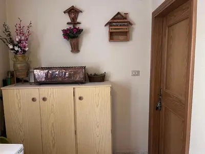 a room with a wooden cabinet with flowers on the wall at Il Rifugio del Brunone in Valda