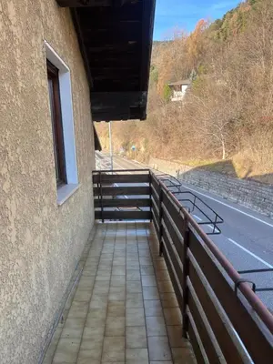 a walkway next to a building next to a road at Il Rifugio del Brunone in Valda