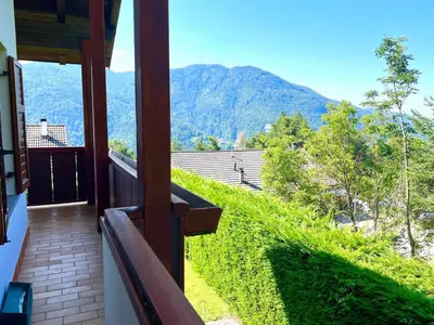 a balcony of a house with a view of the mountains at Villa Grumes by Sunhome Fiemme in Grumes