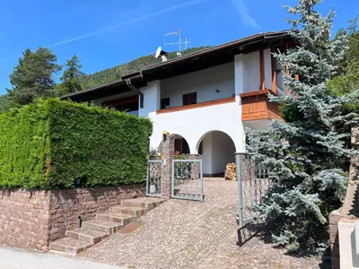 a house with a gate in front of it at Villa Grumes by Sunhome Fiemme in Grumes
