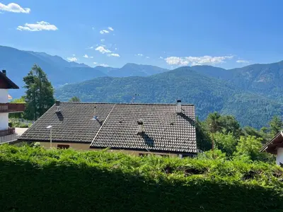 a roof of a house with mountains in the background at Villa Grumes by Sunhome Fiemme in Grumes