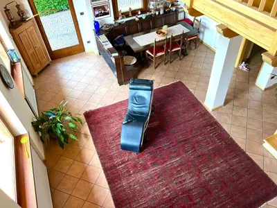 an overhead view of a chair sitting on a rug in a living room at Villa Grumes by Sunhome Fiemme in Grumes