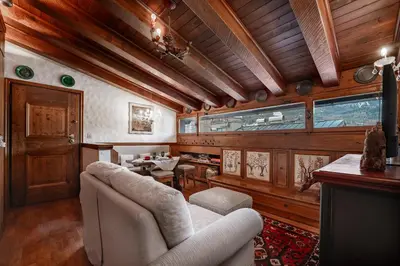 a living room with a couch and a table at GuestHost - Cortina Charming Wooden Alpine Nest in Cortina dʼAmpezzo