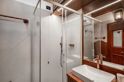 a bathroom with a shower and a sink at GuestHost - Cortina Charming Wooden Alpine Nest in Cortina dʼAmpezzo