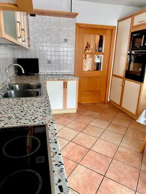 a kitchen with a sink and a counter top at Cesa Bernard - Apartment Cima 12 e new Apartment Fraine in Pozza di Fassa