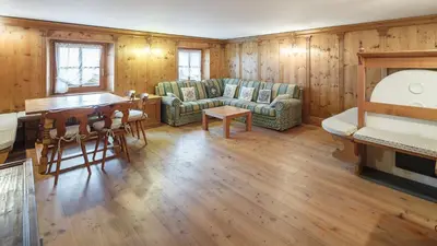 a living room with a couch and a table at Villa Lacedel - Stayincortina in Cortina dʼAmpezzo