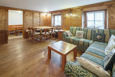 a living room with a couch and a table at Villa Lacedel - Stayincortina in Cortina dʼAmpezzo